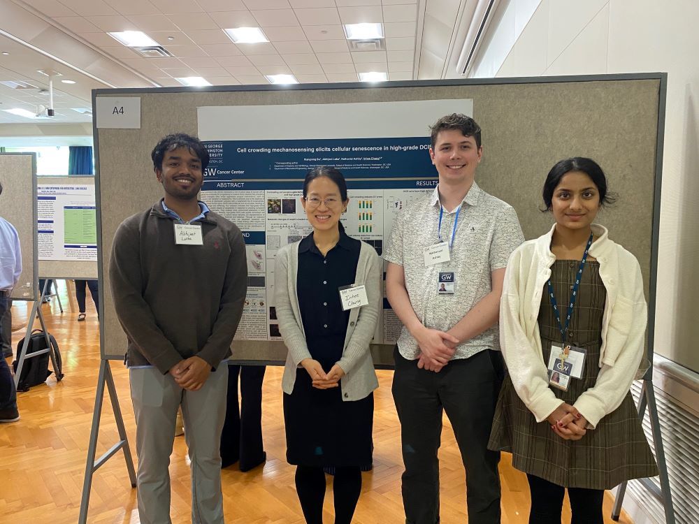 Abhijeet, Nate, Ananya and Dr. Chung with one of the posters from the GWCC retreat.