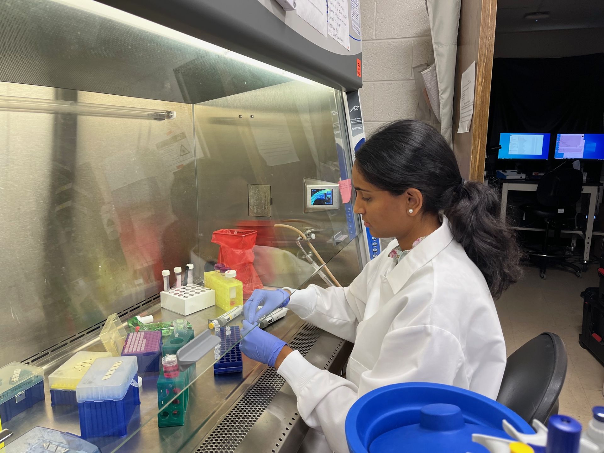 Saanvika doing cell culture work in the BSC.