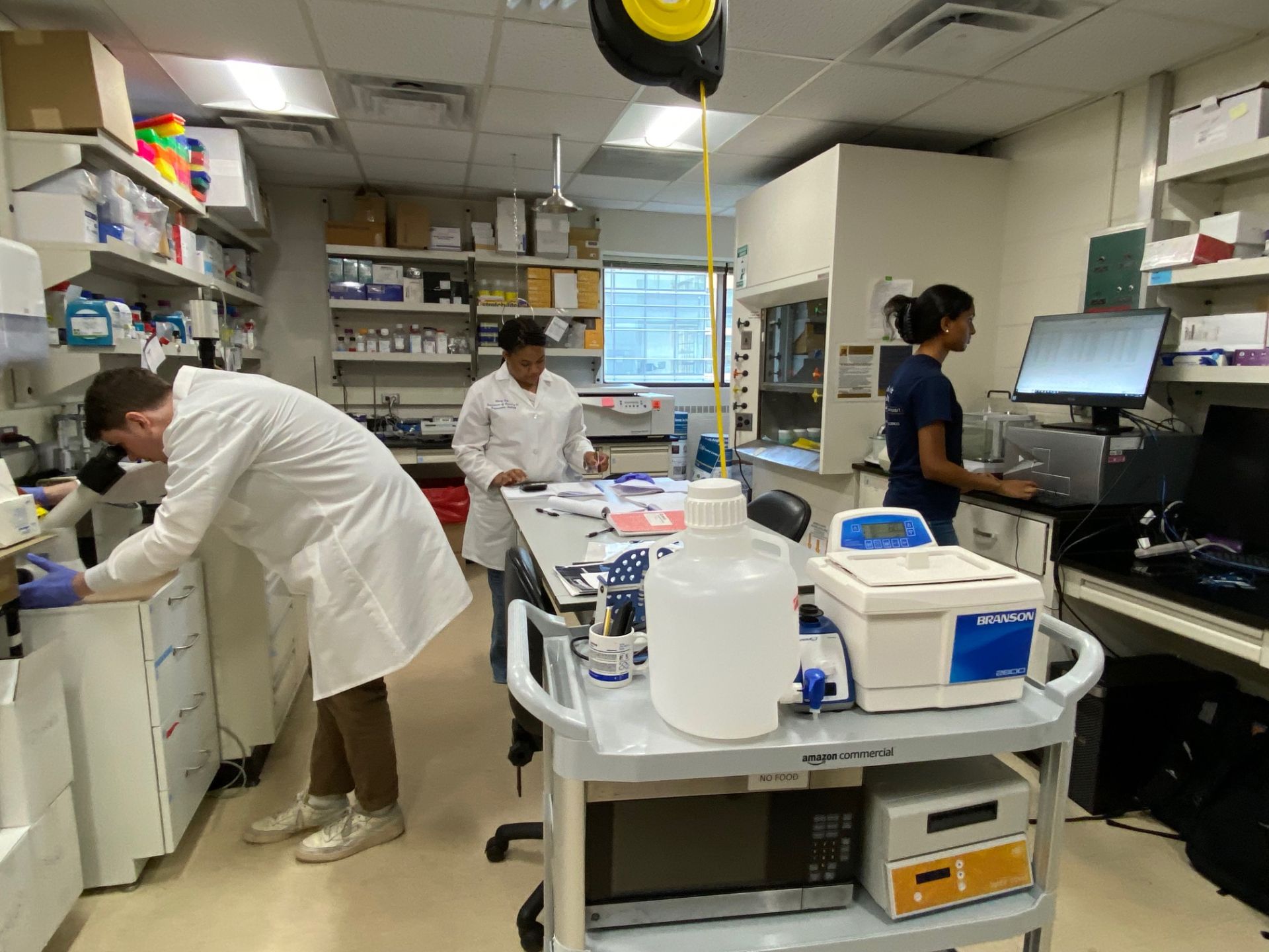 Nate, Semeya, and Saanvika working in the lab.