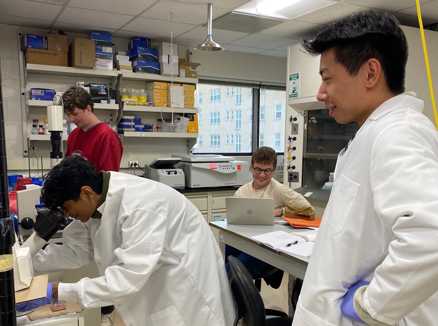 Raghav, Chris, Zach, and Nate working in the lab space