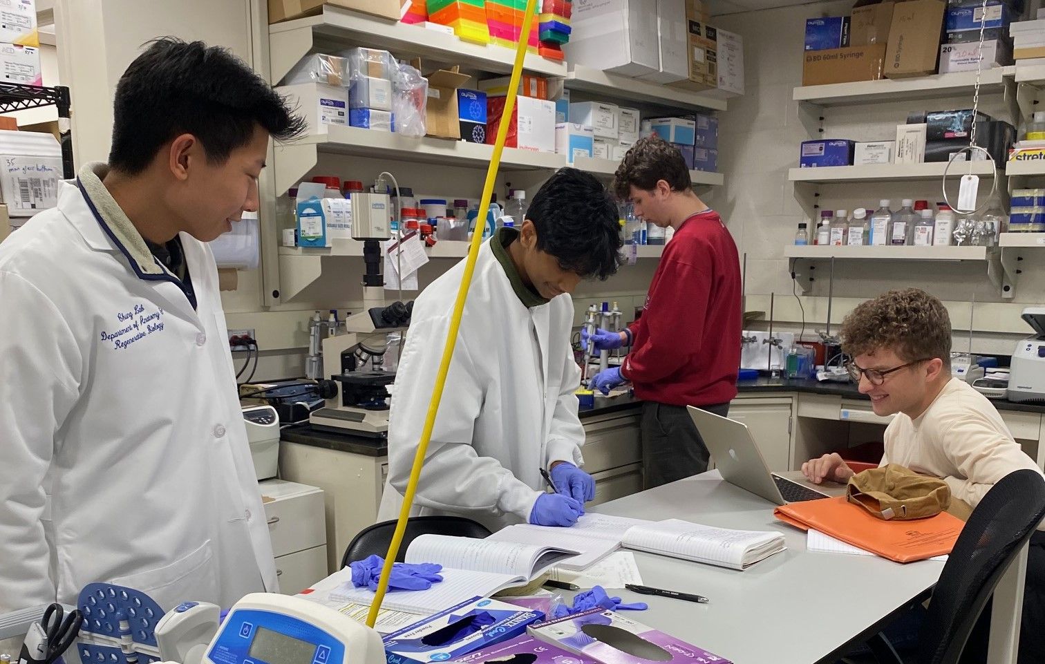 Raghav, Chris, and Zach discussing work in the lab.