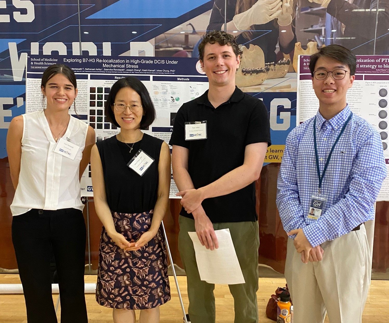 Lucy, Dr. Chung, Nate, and Joseph with Lucy's poster at the SPARC Student poster presentation.